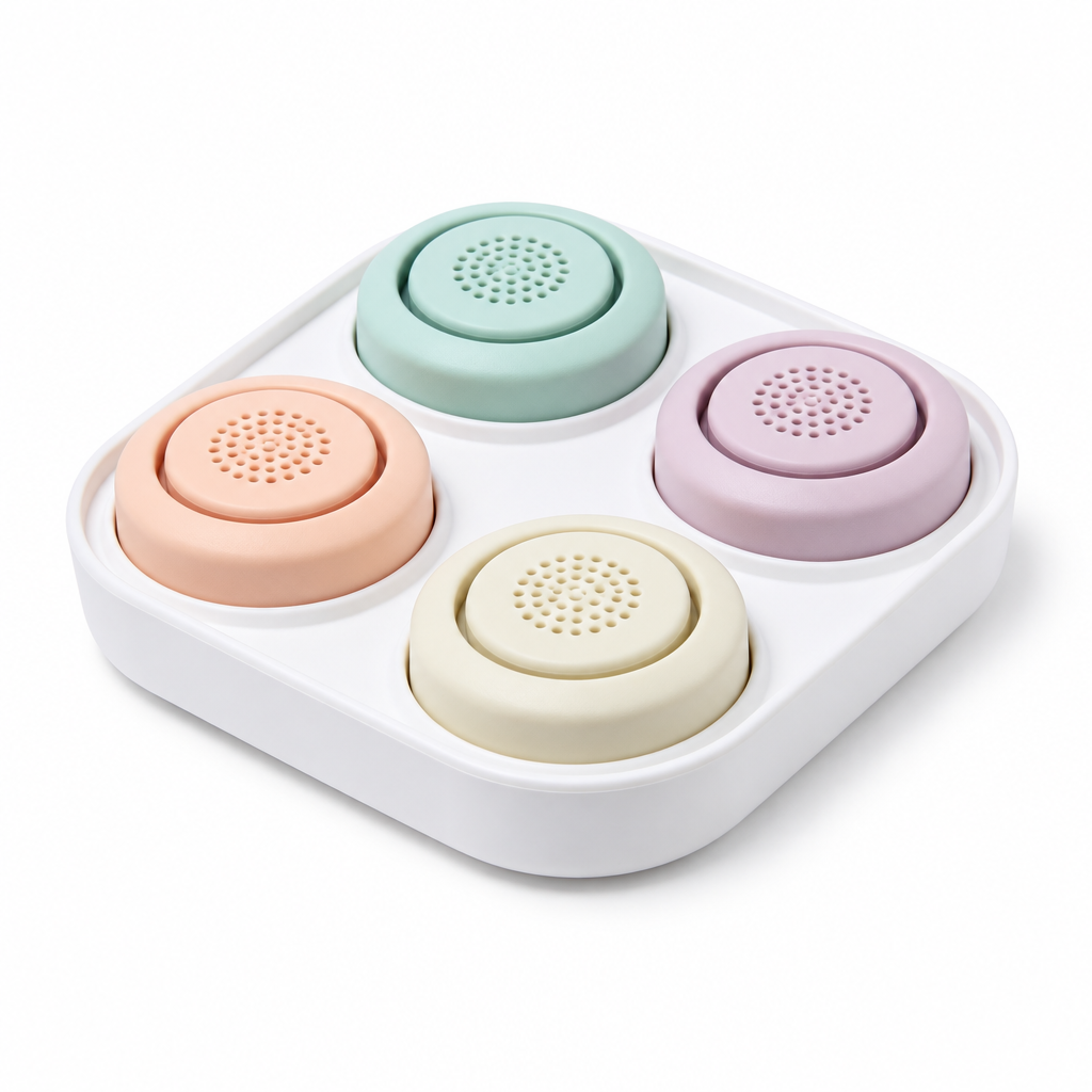 Four pastel pet training buttons in white tray on white