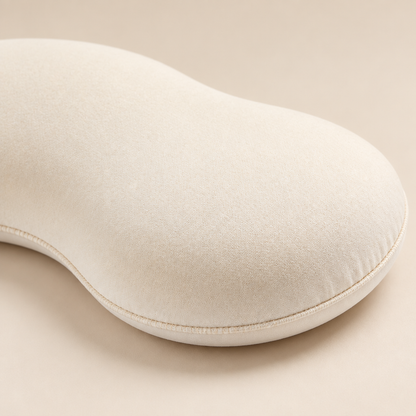 Close-up of the ivory pet pillow's curved edge and seam