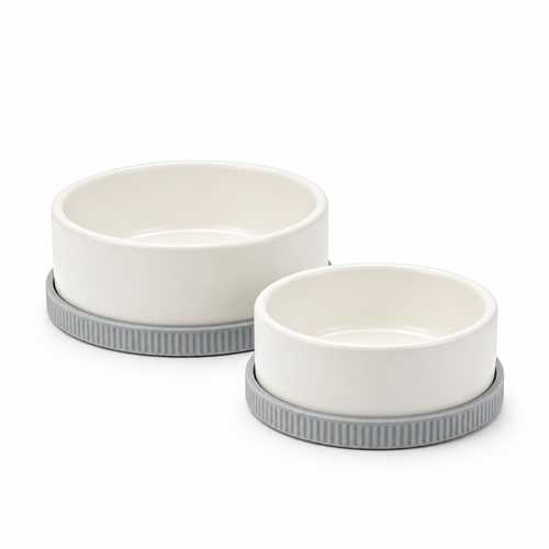 Two ivory pet bowls on gray ribbed bases against white